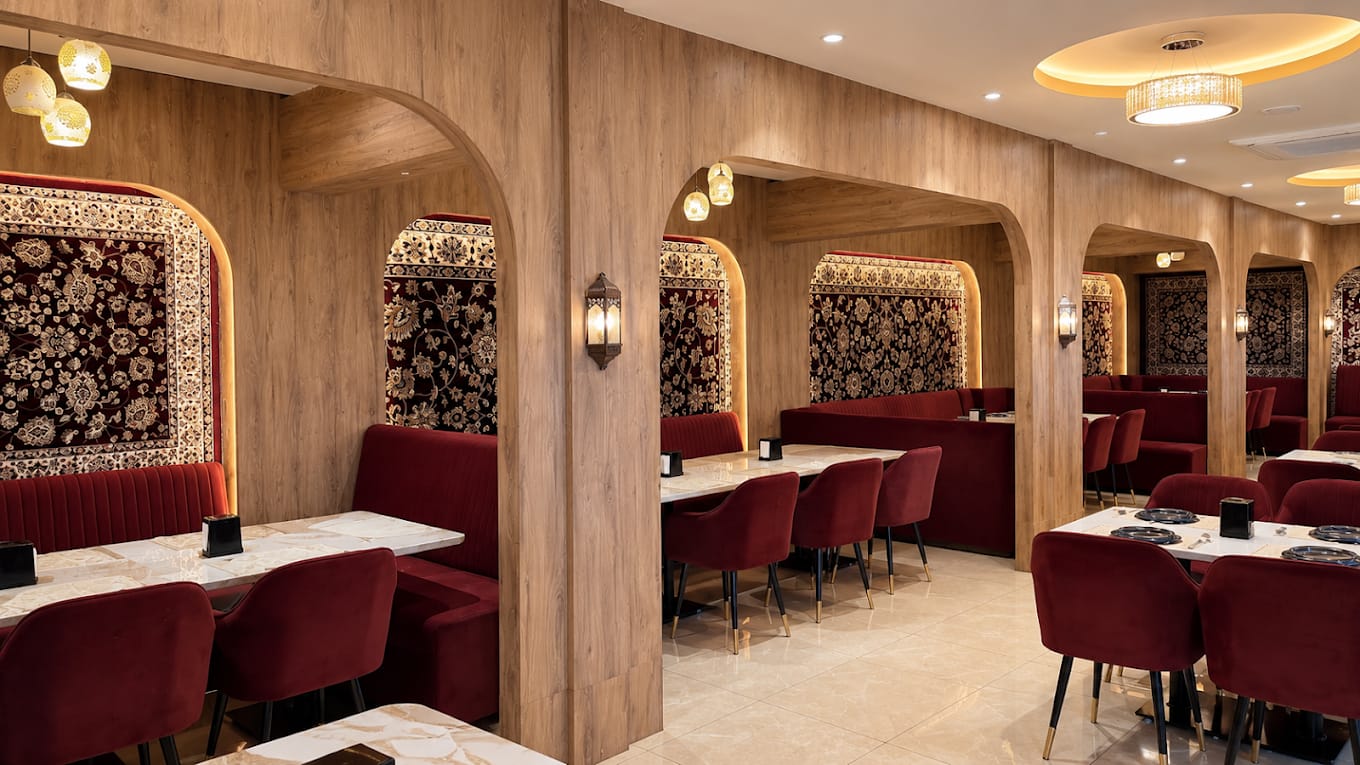 TEHZEEB bar counter with maroon backlighting — a night scene of warm luxury